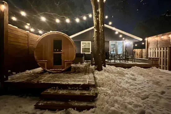 Traverse City Bungalow Spa Getaway | Adventure North Vacation Rentals | Outdoor Hot Tub | Barrel Sauna | Cold Plunge Barrel | String Lit Private Fenced Back Yard | Fire-pit