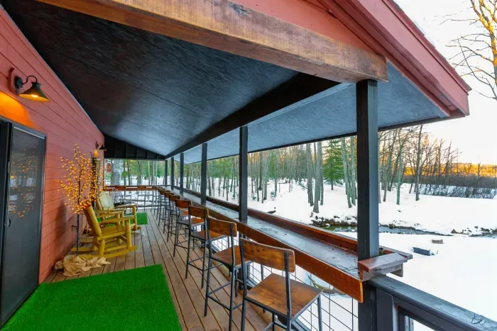 Hall Creek Lodge | Outdoor Covered Porch Creek Views