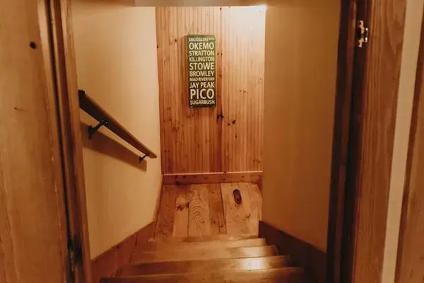 Stairs going down to the family room / game room and bedrooms 3 and 5