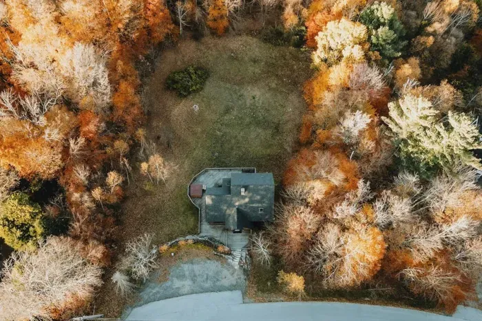 Aerial view of the house and property during foliage season