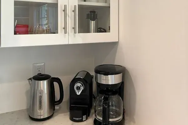 Coffee & tea station with a drip coffee maker and a Nespresso machine. Coffee and tea provided!