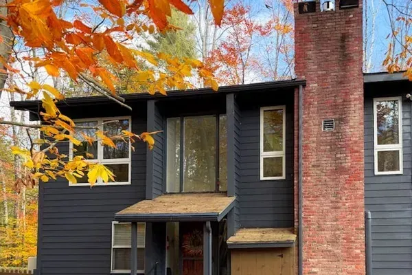 Main entrance with a ski shed to the right 