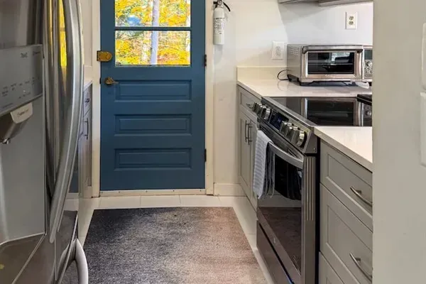 Galley kitchen on the second floor, next to the living and dining areas. 