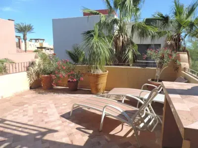 Terrace on the main floor with lounging chairs, patio table and 4 chairs.