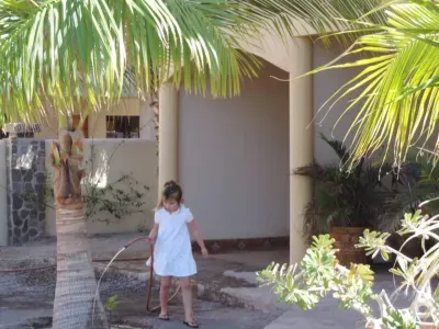 Pearl playing with the hose in the yard