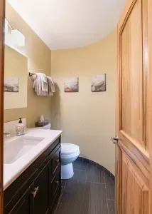 A convenient 2-piece bathroom just inside the main entrance