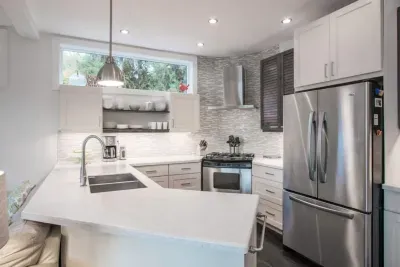 The fully equipped kitchen with natural gas stove, fridge with ice and water, and dishwasher.