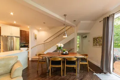 Open-concept dining area with staircase leading to the upper floor.