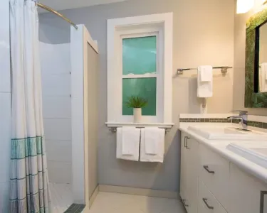 The upper bathroom with 2 sinks, toilet, large shower is on the top floor near 2 of the bedrooms.