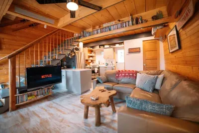 Cozy living room area with 42" Flat screen TV with Roku, Netflix, blue ray DVD player and a library of DVD's.