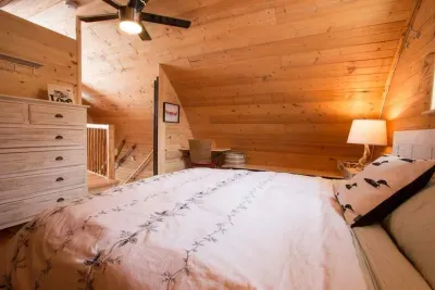 The master bedroom with king bed, large dresser, ceiling fan and its' own convenient desk area. 
The linens are lovely, high quality cotton. and there is a choice of blankets, some down filled, some wool, some cotton, but all very natural fabrics.