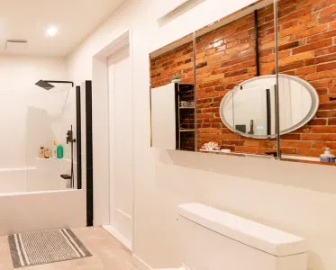 Door in the bathroom leads to the laundry room. The laundry room is shared with the other suite.