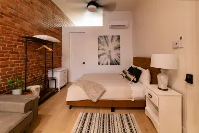 Comfortable queen size bed near door to the bathroom.