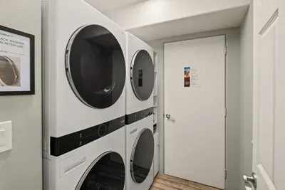 [Laundry Room] Enjoy two washer-dryer units, with laundry supplies and an iron provided for convenience.