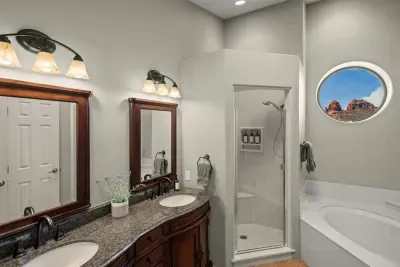 [Bathroom 1] Step into the primary ensuite featuring dual vanities, a glass shower, and a soaking tub.
