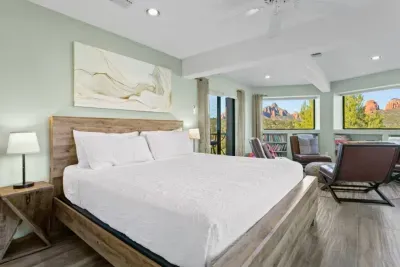 [Bedroom 2] Spacious downstairs king bedroom features panoramic red rock views and quick access to the home's lower level deck with hot tub.