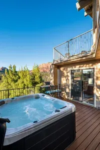 [Hot Tub] Take a step onto the private lower deck for an inviting hot tub session with gorgeous mountain backdrops.