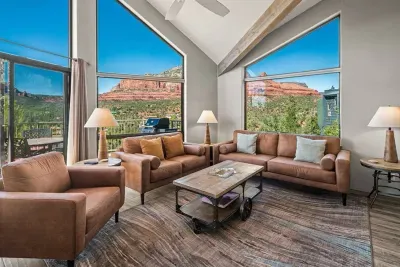 [Living Room] Step into the sunlit living room with expansive windows overlooking red rock vistas.