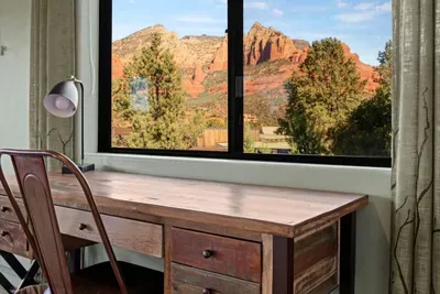 [Bedroom 2] Work or study remotely with the room's dedicated work desk while you admire the beautiful red rock mountain views.