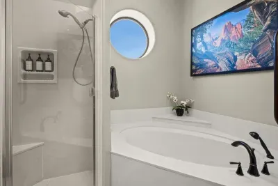 [Bathroom 2] Refresh in the home's glass-enclosed walk-in shower, complete with bathroom products necessary for your stay.