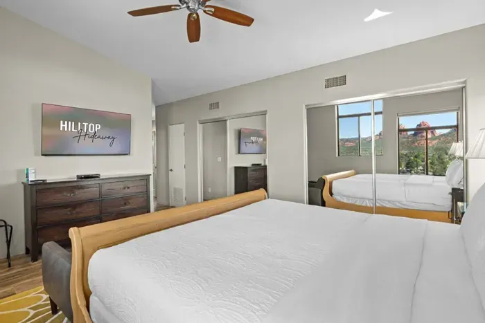 [Bedroom 1] Catch up on your favorite shows from bed with the room's wall-mounted Smart TV.