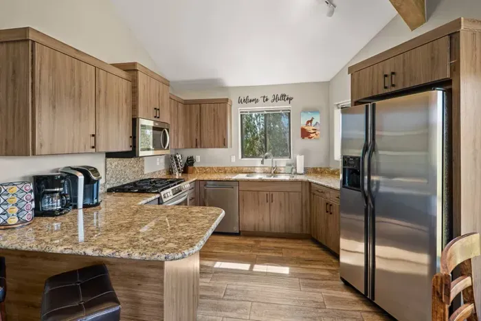 [Kitchen] A fully equipped chef's kitchen featuring ample space to move around as you cook.