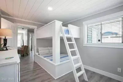 Kids and kids-alike will love this bunk bed room with full-over-full beds. This room provides access to the rear section of the home.