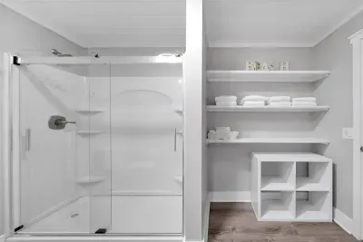 Full bathroom has plenty of shelving to accommodate multiple guests' belongings. 