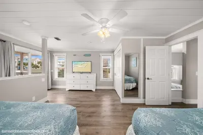 The loft bedroom provides access to the upstairs balcony. Sip coffee while listening to the waves and watching the tide come in.