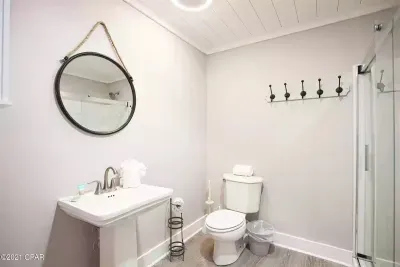 Full bathroom located off secondary living room. This bathroom has lots of great shelving which will help guests keep toiletries conveniently organized and accessible.