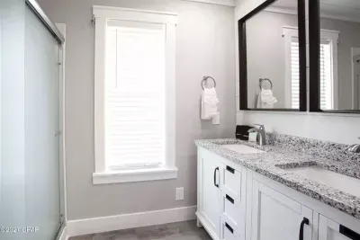 Located just off the upstairs bunk room, this full bathroom boasts a double vanity, perfect for groups. 