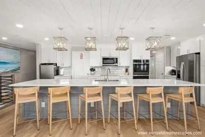 Two fridges! A full-size refrigerator/freezer combination may be seen in the right side of this photo, while a smaller drink refrigerator is located on the left side of this photo. The cooks and beach-goers alike will enjoy the added cooling space.