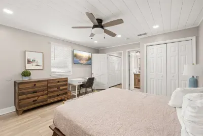 The larger bedroom upstairs has a King bed, bedside tables, and a dedicated desk space. The 55" TV has Roku available. With fast Wifi boosted throughout the home, both work and entertainment are facilitated. 