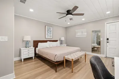 Upstairs Master bedroom with an ensuite bathroom. This beautifully decorated bedroom has a dedicated workspace.