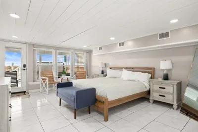 The downstairs beachside west bedroom is equipped with a king bed, seating area, and 55" Roku-enabled TV. Guests may relax after a sun-filled day in the private ensuite full bathroom.