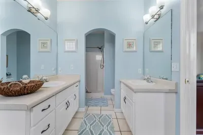 Primary en suite bathroom with a soaking tub, double vanities, and full size shower.