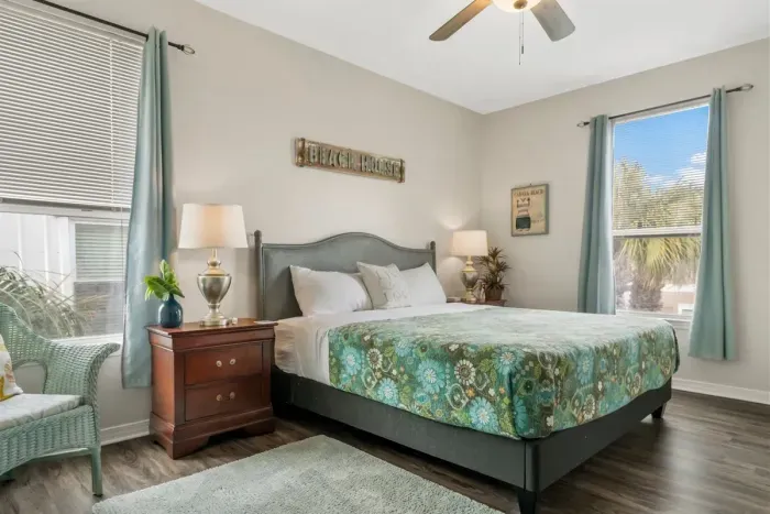 The primary bedroom is located towards the rear of the home with views of the pool and backyard.