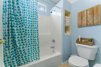 The shower and toilet area are separated from the downstairs vanity.
