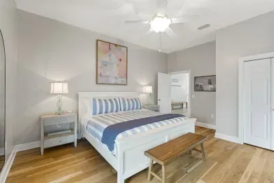 This bedroom is furnished with a King bed. The bathroom is accessed via the hallway.