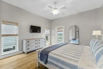 Bedroom with King bed, Roku TV, closet, and shared back porch.