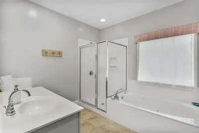 Primary suite en suite bathroom- with walk in shower, tub, double vanities, and potty room.