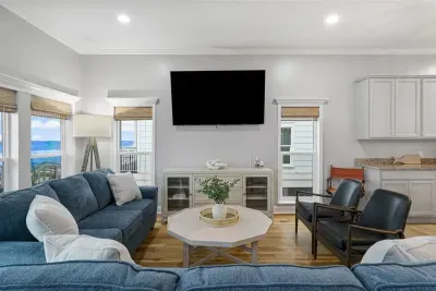 The living room area is furnished with a 75" Roku TV. Family friendly games may be found in the TV console. One of the couches is a pull out sofa with a full mattress.  