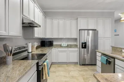 The kitchen is furnished with stainless steel appliances and all the dishes and kitchen ware needed to cook for the crowd!