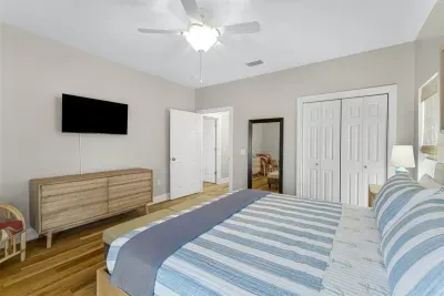 King bedroom with Roku TV, closet, and shared backporch access.