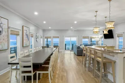 The Keeping Room is an open-concept kitchen, dining, gathering, and seating area framed by ocean front views.