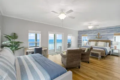The primary suite, on the 2nd level, is furnished with a king size bed and full-over-twin trundle. A private porch provides access to the beautiful beach-front views.