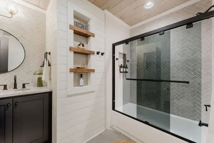 Unique touches to the tub/shower combo with tinted glass.