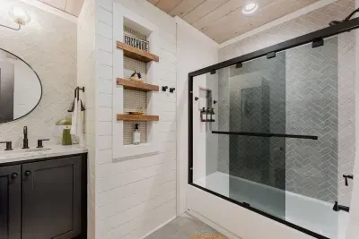 Unique touches to the tub/shower combo with tinted glass.