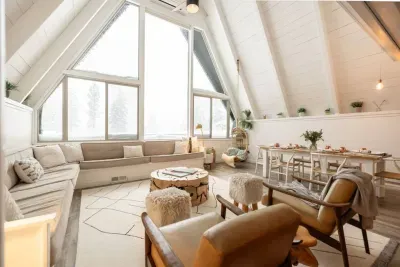 Winter vibes at Stuga '66: Our living room and dining area face towards huge picture windows. You won't want to leave this space!