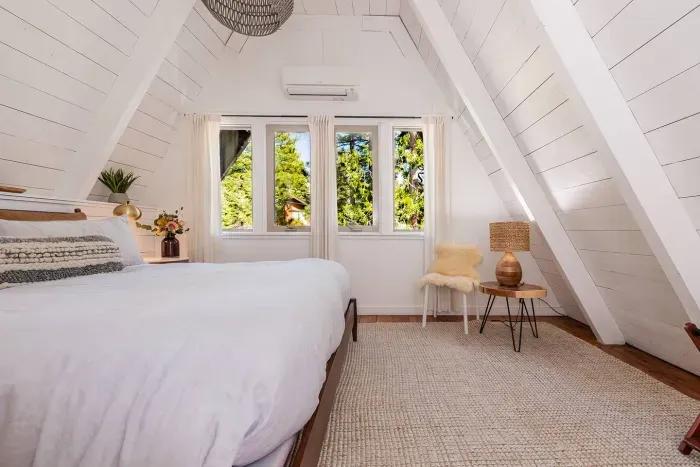 Wake up refreshed! The upstairs bedroom features comfortable king bed, cotton sheets, fluffy duvet and an assortment of pillows. Complete with side table + seating area, luggage rack, mini split w/ AC. The upstairs bath is just a few steps away